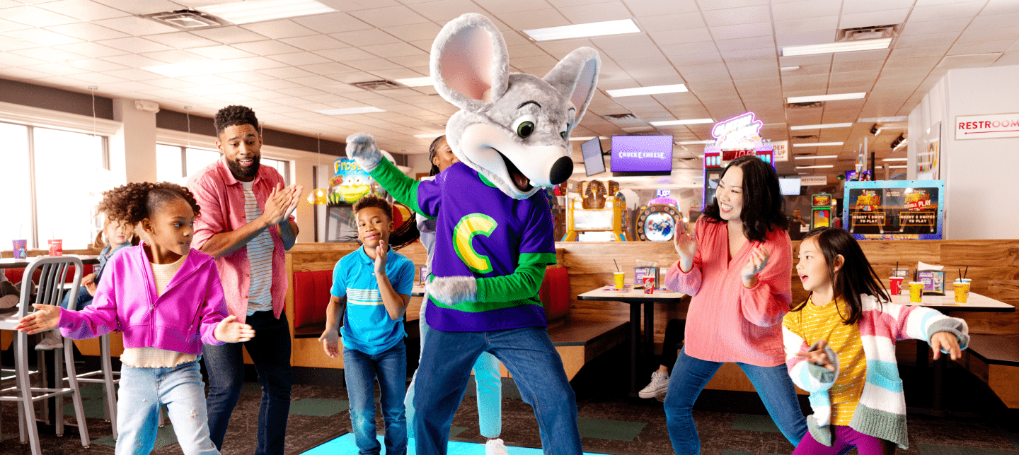Chuck E. on the dance floor with kids and parents