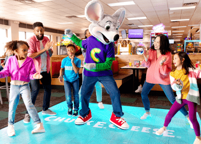 Chuck E. on the dance floor with kids and parents alike.